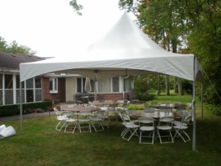 Event tent with round tables and chairs under it