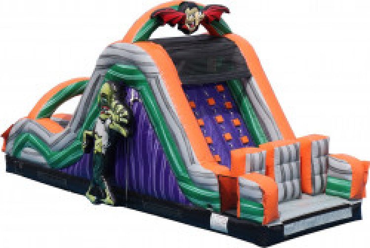 15-foot inflatable slide with attached climbing wall and attached Dracula and Frankenstein decor pieces in Norton, OH. - Game Craze Party & Event Rentals